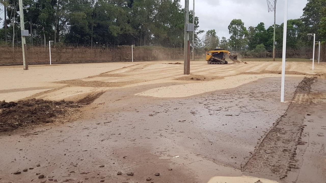 Colleen Miller said mud two-inches thick blanketed the netball courts, which then required a Bobcat from the Queensland Fire and Emergency Service to scrape away. Photo: Facebook