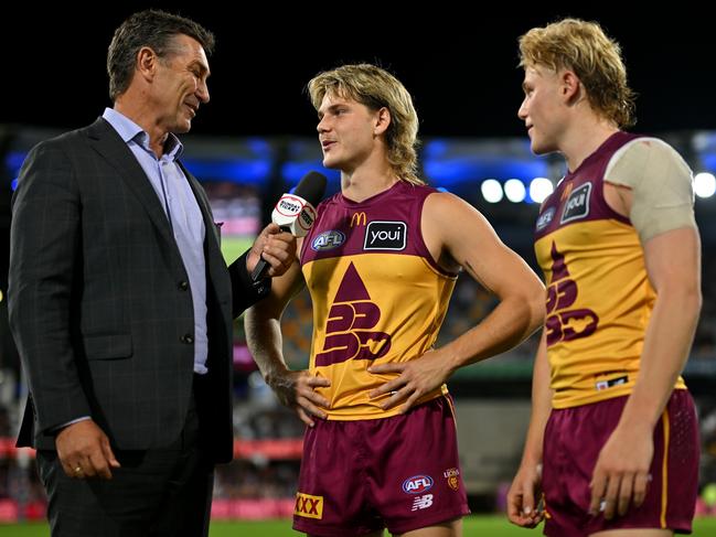 Lions great Alastair Lynch (left) discusses Brisbane’s QClash win with Will (centre) and Levi Ashcroft. Picture: Albert Perez/AFL Photos via Getty Images