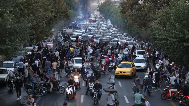 Iranian demonstrators taking to the streets of the capital Tehran during a protest for Mahsa Amini, days after she died in police custody.