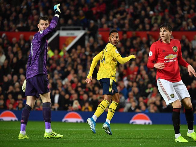 Arsenal's Gabonese striker Pierre-Emerick Aubameyang (C) looks to the assistant referee after scoring, decision of off-side overturned by VAR (Video Assistant referee) during the English Premier League football match between Manchester United and Arsenal at Old Trafford in Manchester, north west England, on September 30, 2019. (Photo by Paul ELLIS / AFP) / RESTRICTED TO EDITORIAL USE. No use with unauthorized audio, video, data, fixture lists, club/league logos or 'live' services. Online in-match use limited to 120 images. An additional 40 images may be used in extra time. No video emulation. Social media in-match use limited to 120 images. An additional 40 images may be used in extra time. No use in betting publications, games or single club/league/player publications. /