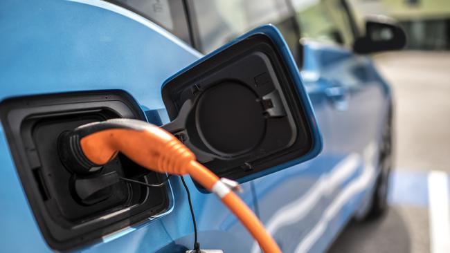 Power cord charging an electric car.