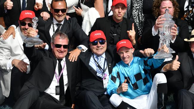 Trainer Darren Weir and jockey John Allen celebrate with the owners of Extra Brut. Picture: Getty Images