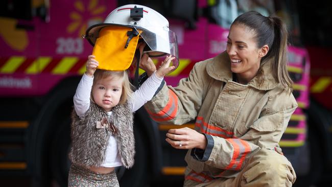 Firefighter Brooke Field with her daughter Cleo at the Adelaide Fire Station. Picture: Matt Turner