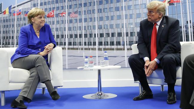 Donald Trump shares a bit of distance with German Chancellor Angela Merkel. Picture: AP