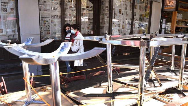 Tables and chairs are stacked up on the Lygon Street cafe and restaurant strip in Melbourne on Wednesday with the coronavirus lockdown of Australia's second-biggest city extended by another seven days, authorities announced as they attempt to stamp out a cluster of cases in Melbourne. Picture: William West / AFP)