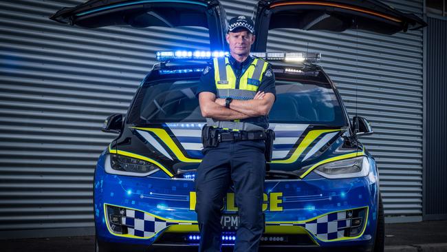 Inspector Stuart Bailey with the new Tesla highway patrol car. Picture: Picture: Jake Nowakowski