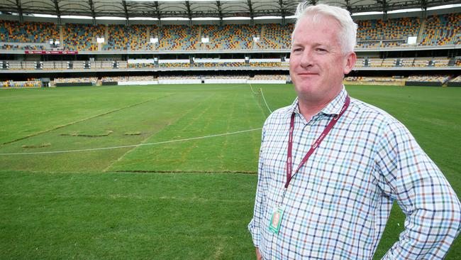 Gabba manager Blair Conaghan inspects the grass repairs at the Gabba after the Adele concert. Picture: Liam Kidston