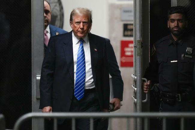 Donald Trump returns after a break during his criminal trial for allegedly covering up hush money payments