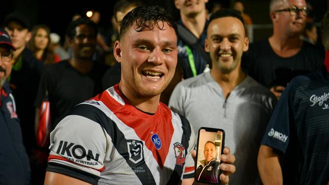 Debutant Lachlan Lam Facetimes his dad Adrian after the Roosters’ victory. Gregg Porteous © NRL Photos