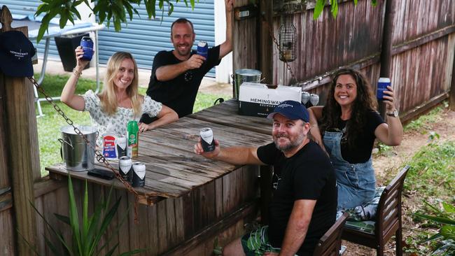 Handyman Darryl Strugnell, front, built a bar into his fence at Woree, Cairns, in April 2020 so he and his wife, Louise, could have drinks with the neighbours, Carly and Stephen Parsons. Picture: Brendan Radke