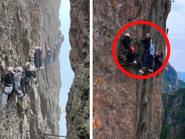 The moment tourists were filmed dangling from a mountain.