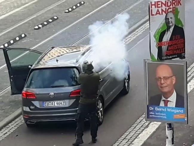 In this image taken from video made available by ATV-Studio Halle, a man shoots from long-barrelled gun, in Halle, Germany. Picture: AP