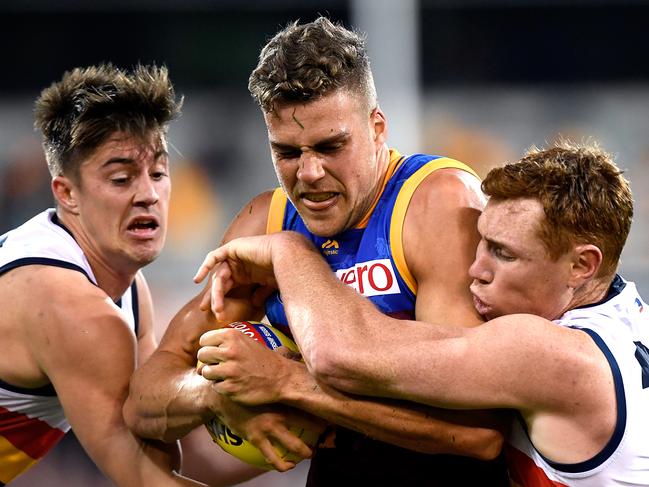 BRISBANE, AUSTRALIA - JULY 21:  Tom Cutler of the Lions is pressured by the defence during the round 18 AFL match between the Brisbane Lions and the Adelaide Crows at The Gabba on July 21, 2018 in Brisbane, Australia.  (Photo by Bradley Kanaris/Getty Images)