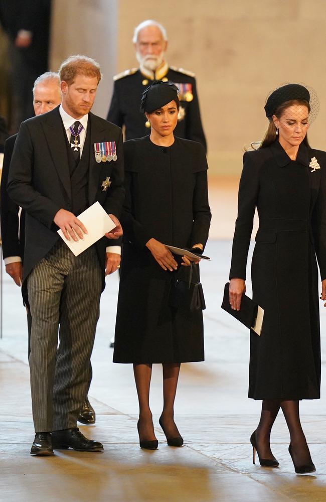 Prince Harry, Meghan, Duchess of Sussex and Catherine, Princess of Wales stand at the coffin of the Queen at Westminster Hall. Picture: Jacob King/Getty Images