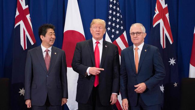 Japan's Prime Minister Shinzo Abe, left, US President Donald Trump and Prime Minister Malcolm Turnbull attend a trilateral meeting at ASEAN.