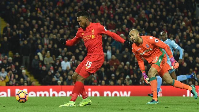 Liverpool's English striker Daniel Sturridge (L) slots the ball home to score.