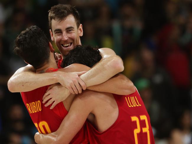 Spanish players celebrate defeating the Boomers in the bronze medal match.