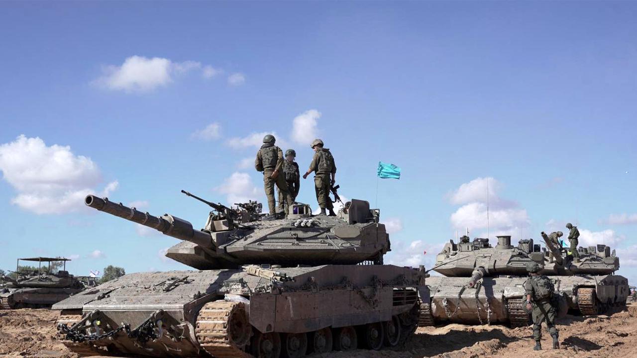 Israeli soldiers standing atop a main battle tank as part of the Givati Brigade operating in eastern Rafah in the southern Gaza Strip. Picture: AFP