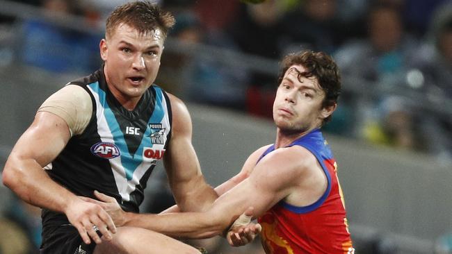 Ollies Wines and Lachie Neale battle it out at Adelaide Oval. Picture: Daniel Pockett/Getty