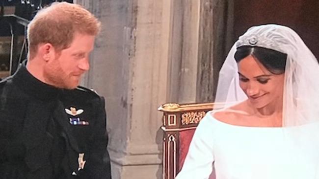 The couple couldn’t hide their smiles during the solemn moment.