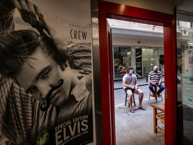 Long lines for a haircut should ease after 6pm Friday, when indoor density limits change. Picture: Ian Currie