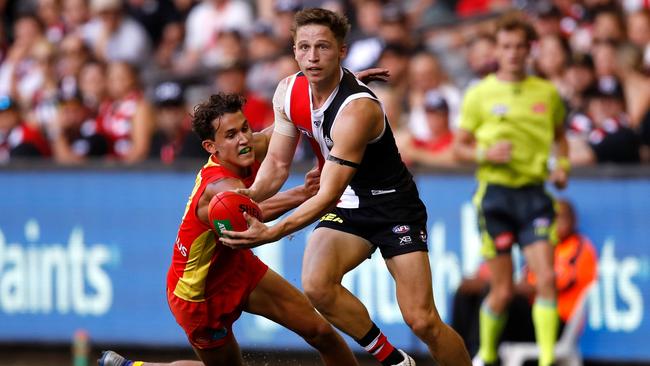 Jack Billings dashes past Gold Coast Suns midfielder Wil Powell in Round 1. Picture: Dylan Burns/AFL Photos. 