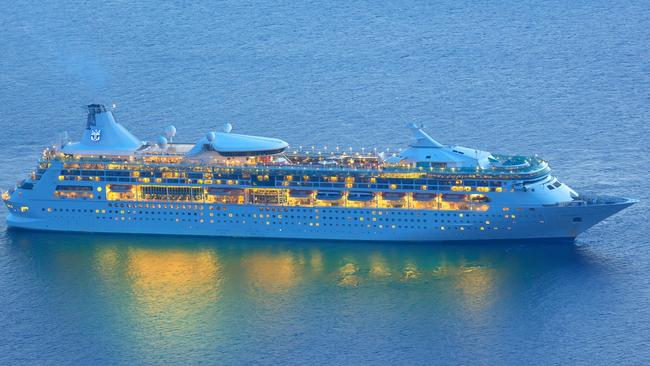 Santorini, Greece - October 17, 2015: Cruise ship " MS Rhapsody of the Seas " from Royal Caribbean International seen from the isalnd of Santorini, Greece in the dawn  Picture: istock