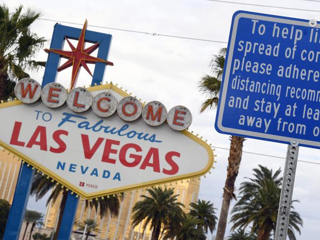 (FILES) In this file photo taken on March 22, 2020, a sign placed in front of the Welcome to Fabulous Las Vegas sign displays a message about social distancing due to the continuing spread of the coronavirus in Las Vegas, Nevada. - NBA officials are studying the possibility of staging the entire playoffs in Las Vegas but nothing is close to being settled, Sports Illustrated reported April 2, 2020. (Photo by Ethan Miller / GETTY IMAGES NORTH AMERICA / AFP)