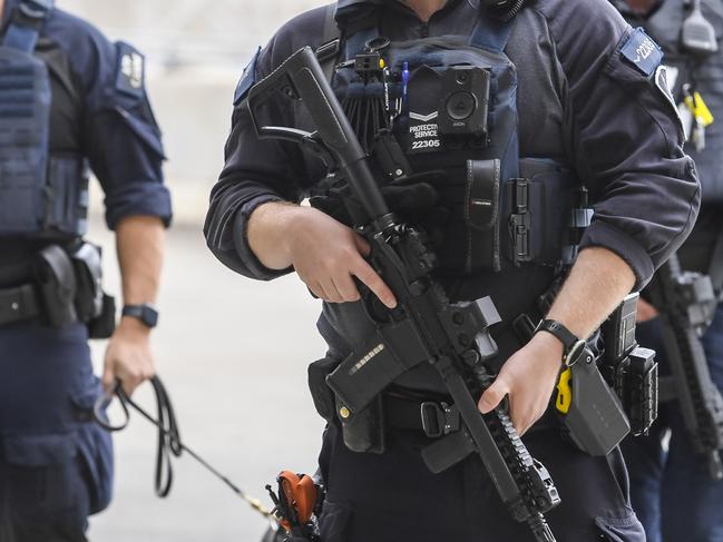 ADELAIDE, AUSTRALIA - NewsWire Photos DECEMBER 18 2023:  AFP AIRPORT PATROL. Protective service officer Brendan Bates, Leading Senior Constable Dean Poletta, K9 Jack and Protective Service Officer Grade 1 Patrick Barry.Picture: NCA NewsWire / Roy VanDerVegt