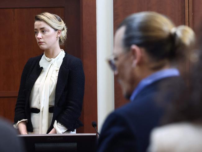 US actor Amber Heard testifies as US actor Johnny Depp looks on during a defamation trial at the Fairfax County Circuit Courthouse in Fairfax, Virginia, on May 5, 2022. Picture; Jim LO SCALZO / AFP.