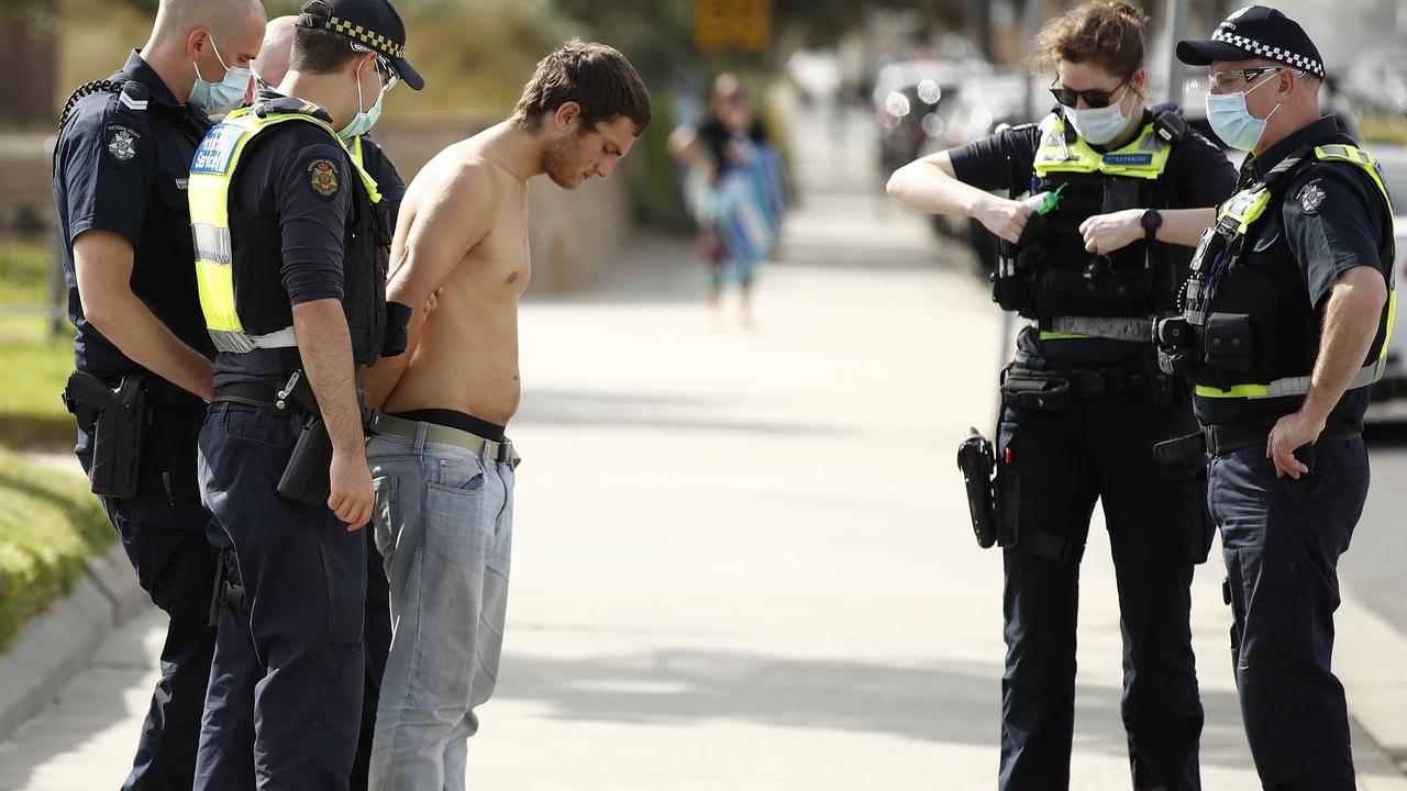 Another protester being arrested, this time at St Kilda beach. Picture: Daniel Pockett/NCA NewsWire