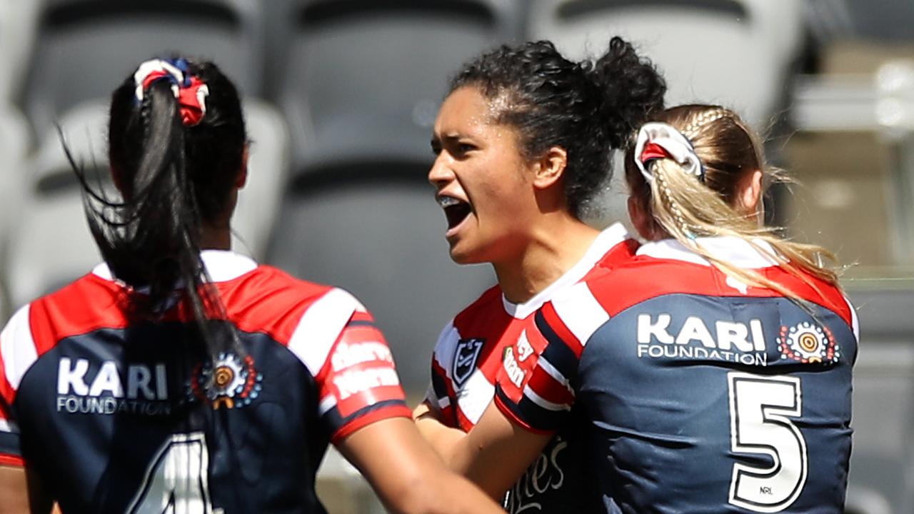 Zahara Temara is swamped by teammates after scoring against the Warriors. Picture: Getty Images