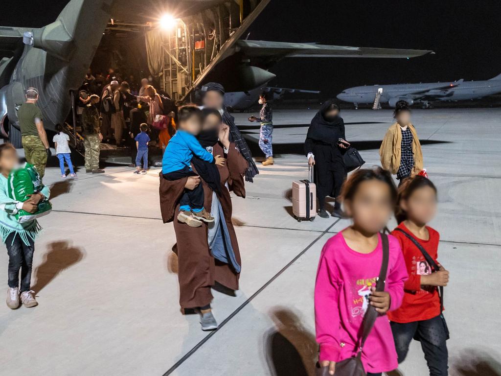 Children from Afghanistan disembark a Royal Air Force C-130 Hercules at Australia’s main operating base in the Middle East. Picture: Defence