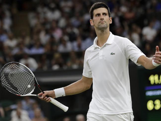 Serbia's Novak Djokovic reacts after play was suspended during his men's singles semi-final match against Spain's Rafael Nadal