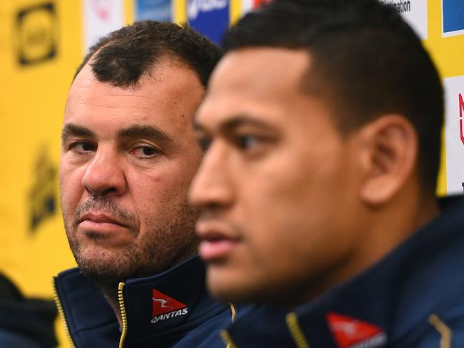 Wallabies coach Michael Cheika, (left), looks on as Israel Folau speaks during a media conference at the Sydney Cricket Ground, in Sydney, Tuesday, Aug. 4, 2015. The Wallabies play the All Blacks in the Rugby Championship decider in Sydney on Saturday. (AAP Image/Dan Himbrechts) NO ARCHIVING