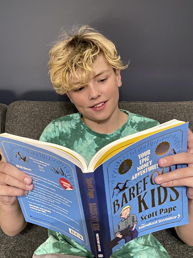 10-year-old Caleb reading Scott Pape’s new book Barefoot Kids.