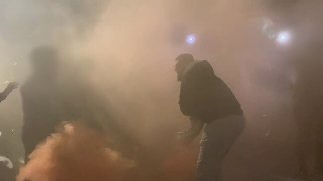 Police have released images and video of a man throwing a flare at Monday's pro-Palestine rally as they investigate "unlawful activity" at the protest, which turned violent.