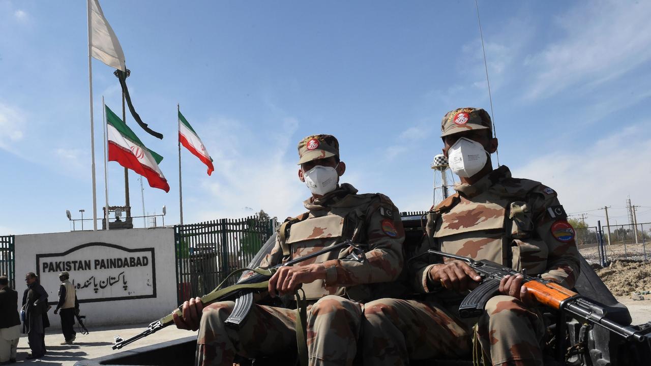 Pakistani soldiers wear face masks as they patrol near the closed Pakistan-Iran border. Picture: Banaras KHAN/AFP