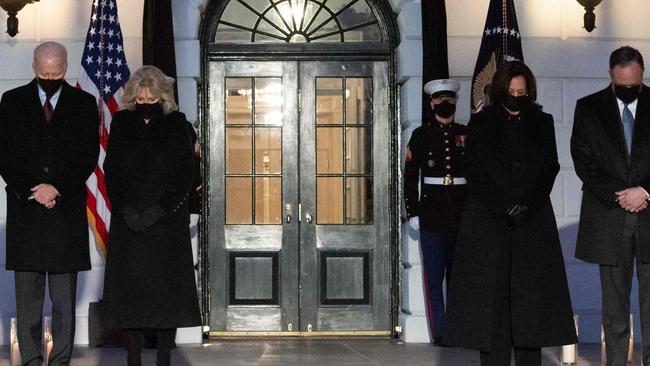 US President Joe Biden, First Lady Jill Biden, Vice President Kamala Harris and her husband, Doug Emhoff, hold a moment of silence during a candelight ceremony in honor of those who lost their lives to Coronavirus. Picture: Saul Loeb/AFP