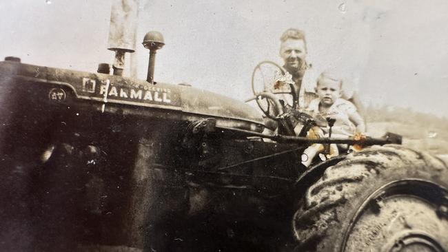 Allan Page and his son, Neil, on a tractor on the cane farm.