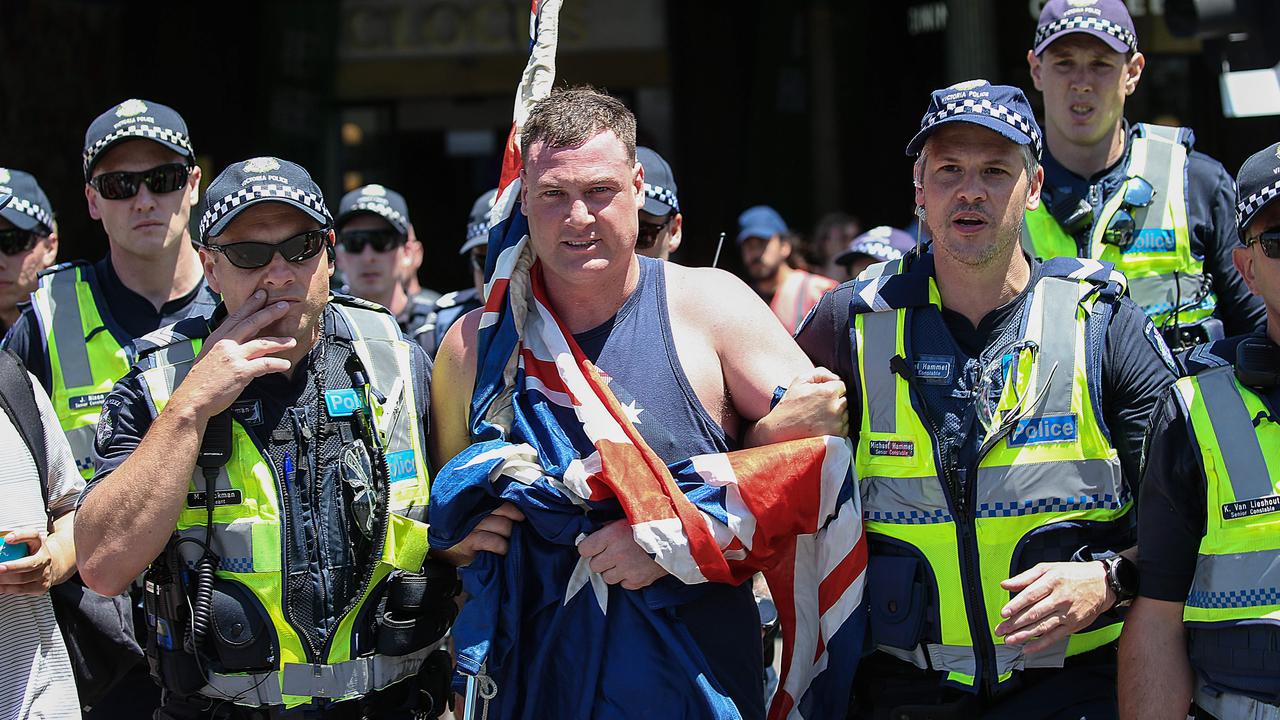 A member from the Nationalist Uprising is arrested by police at the Invasion Day rally in Melbourne. Picture: Ian Currie
