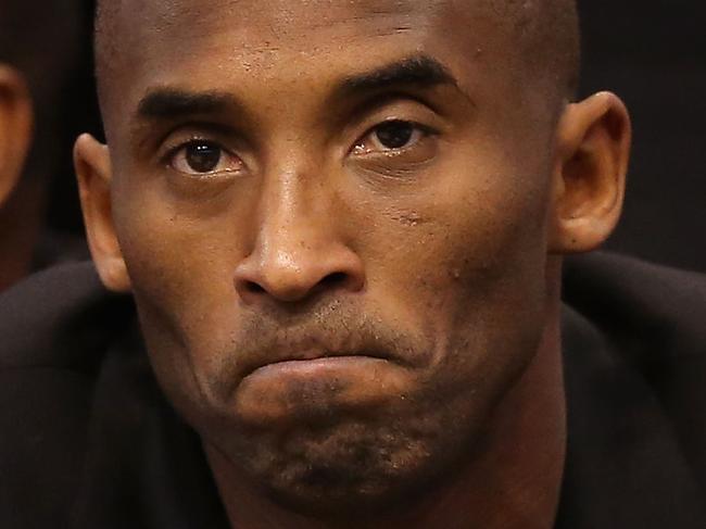 PHOENIX, AZ - JANUARY 15: Kobe Bryant #24 of the Los Angeles Lakers watches from the bench during the NBA game against the Phoenix Suns at US Airways Center on January 15, 2014 in Phoenix, Arizona. NOTE TO USER: User expressly acknowledges and agrees that, by downloading and or using this photograph, User is consenting to the terms and conditions of the Getty Images License Agreement. (Photo by Christian Petersen/Getty Images)