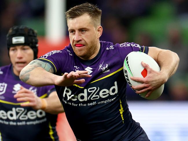 MELBOURNE, AUSTRALIA - AUGUST 03: Cameron Munster of the Storm makes a break during the round 22 NRL match between Melbourne Storm and St George Illawarra Dragons at AAMI Park, on August 03, 2024, in Melbourne, Australia. (Photo by Josh Chadwick/Getty Images)