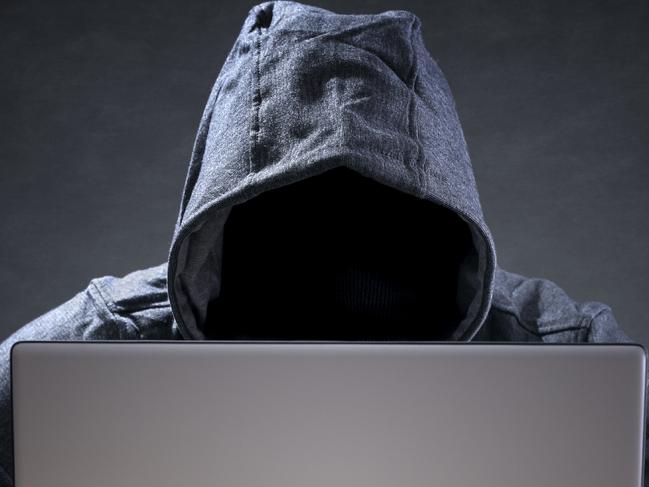 Computer hacker stealing data from a laptop concept for network security, identity theft and computer crime