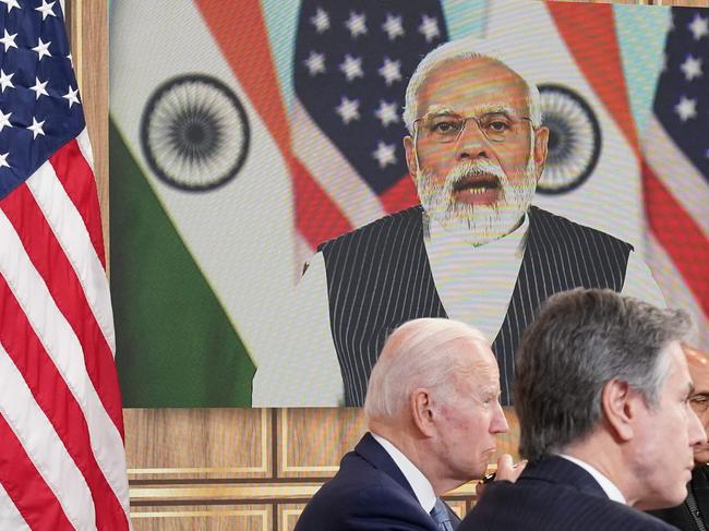 US President Joe Biden (L) alongside India's Minister of Defense Rajnath Singh (R) and US Secretary of State Antony Blinken (C), takes part in a virtual meeting with India's Prime Minister Narendra Modi in the South Court Auditorium of the Eisenhower Executive Office Building next to the White House in Washington DC on April 11, 2022. (Photo by MANDEL NGAN / AFP)