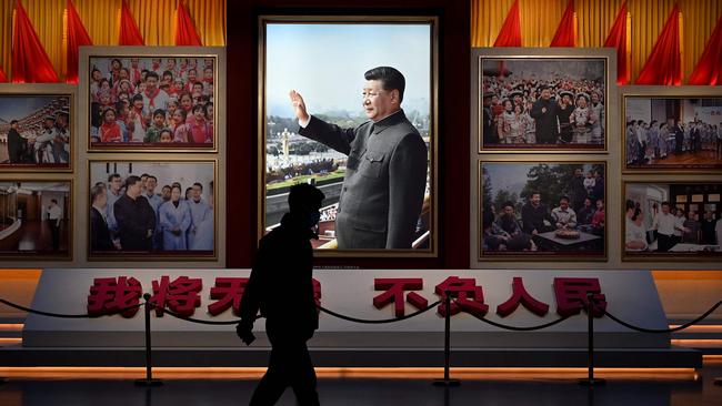 A man walks in front of a picture of Xi Jinping at the Museum of the Communist Party of China in Beijing on Thursday. Picture: AFP