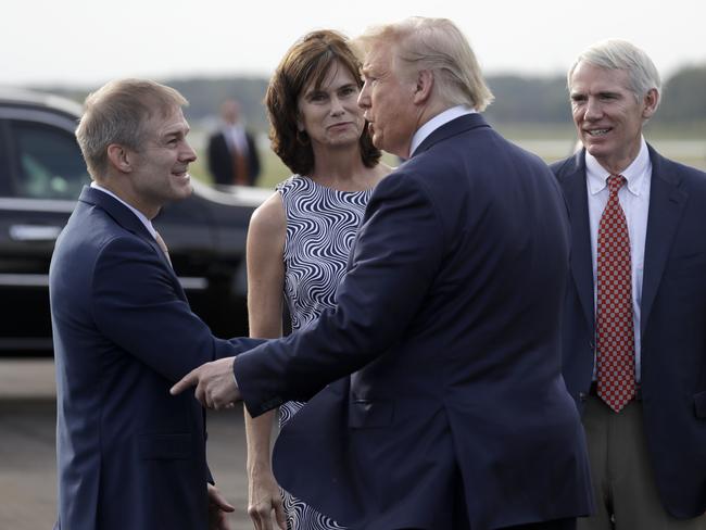 President Donald Trump was greeted by Ohio Republican Jim Jordan, left, Ohio Republican Senator Rob Portman and his wife Jane as he arrived to tour Pratt Industries. Picture: AP