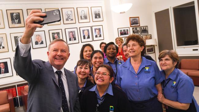 Australian Opposition Leader Anthony Albanese poses for a selfie with Parliament House cleaning staff during International Cleaners Day at Parliament House in Canberra on Monday.