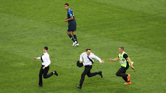 Pitch invaders are chased by security staff during the 2018 FIFA World Cup Final between France and Croatia at Luzhniki Stadium. Photo: Getty Images