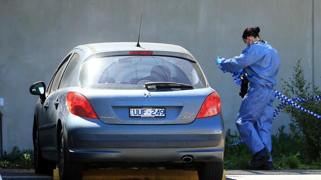 Forensics examine a car outside Mernda police station at a second crime scene after an woman was found dead. Picture: Mark Stewart